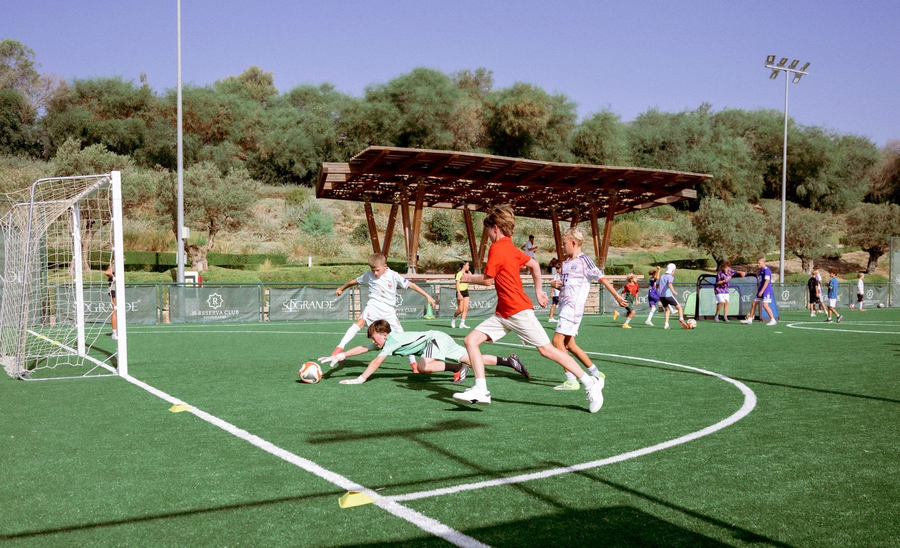 A Soto FC goalkeeper diving full stretch to smother the ball during a session at La Reserva.