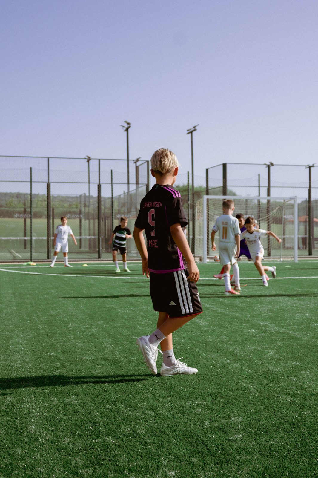 A player watching play develop from the halfway line