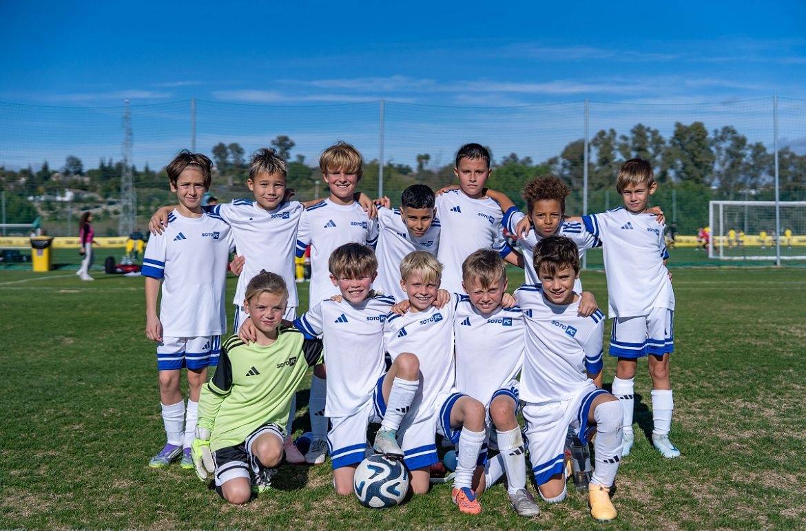 A younger Soto FC squad photographed together on the grass, a ball at their feet